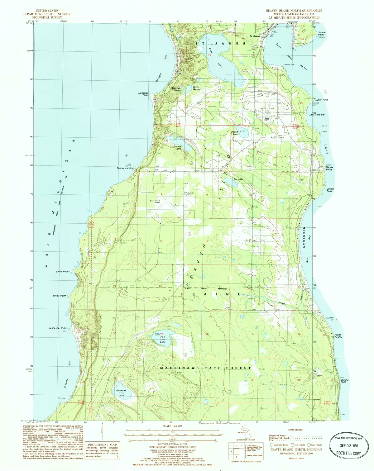 Topographic map showing a forested peninsula, surrounding water, roads, trails, ponds, and contour lines.