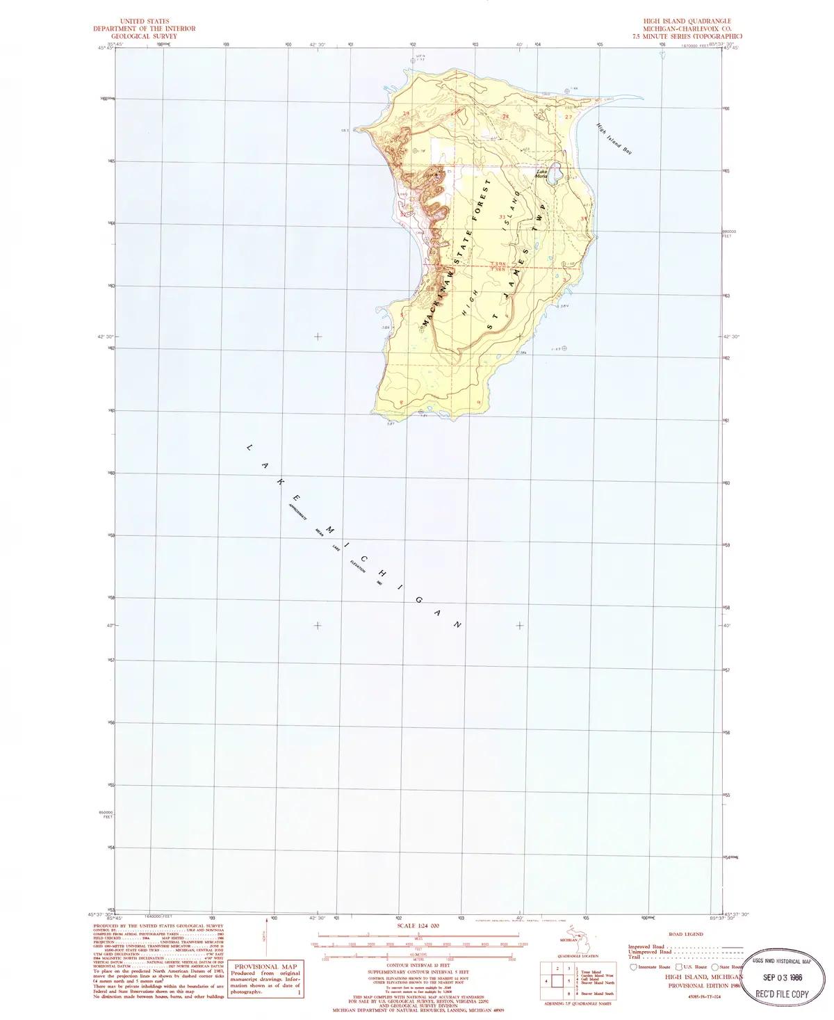 Topographic map showing a wooded landmass, shoreline, contours, roads, and surrounding water.