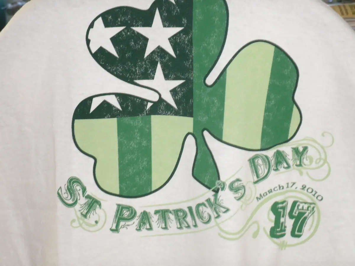 Close-up of a green-and-white St. Patrick's Day graphic printed on a shirt.