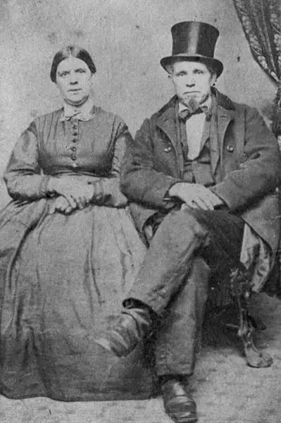 Black-and-white studio portrait of a seated woman and bearded man in formal nineteenth-century clothing.