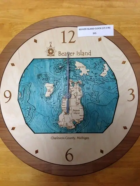 Round wooden wall clock with a blue map inset, compass rose, large numerals, and a small price label.