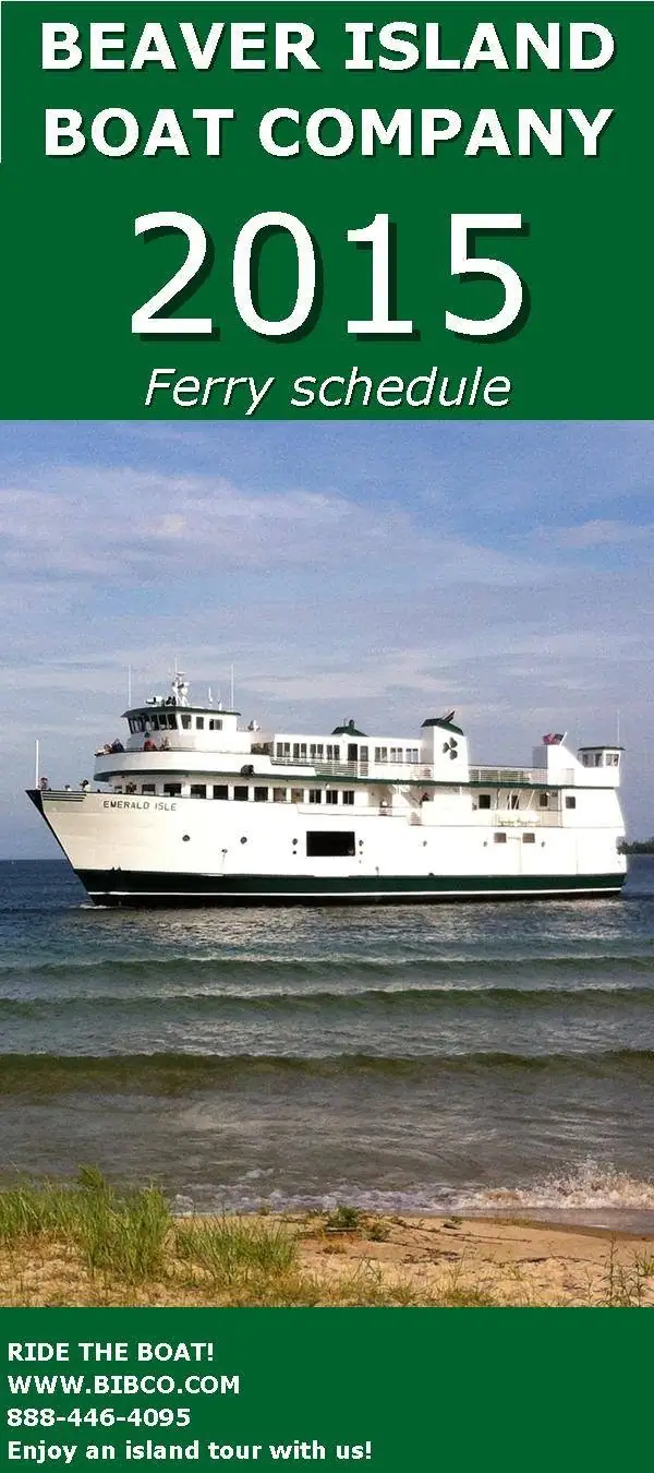 A promotional ferry-schedule poster shows the white passenger vessel Emerald Isle offshore beyond a sandy shoreline.