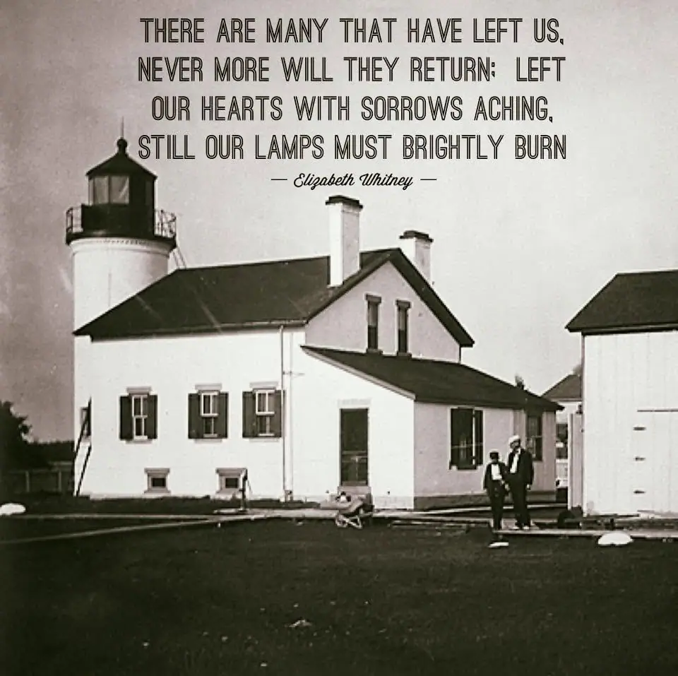 Black-and-white photograph of a lighthouse complex with two people standing beside the buildings and a quotation above.