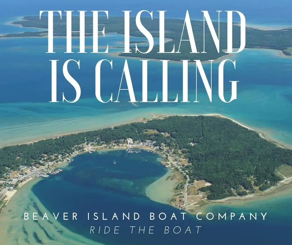 Aerial view of a wooded shoreline settlement and harbor beneath large promotional lettering.