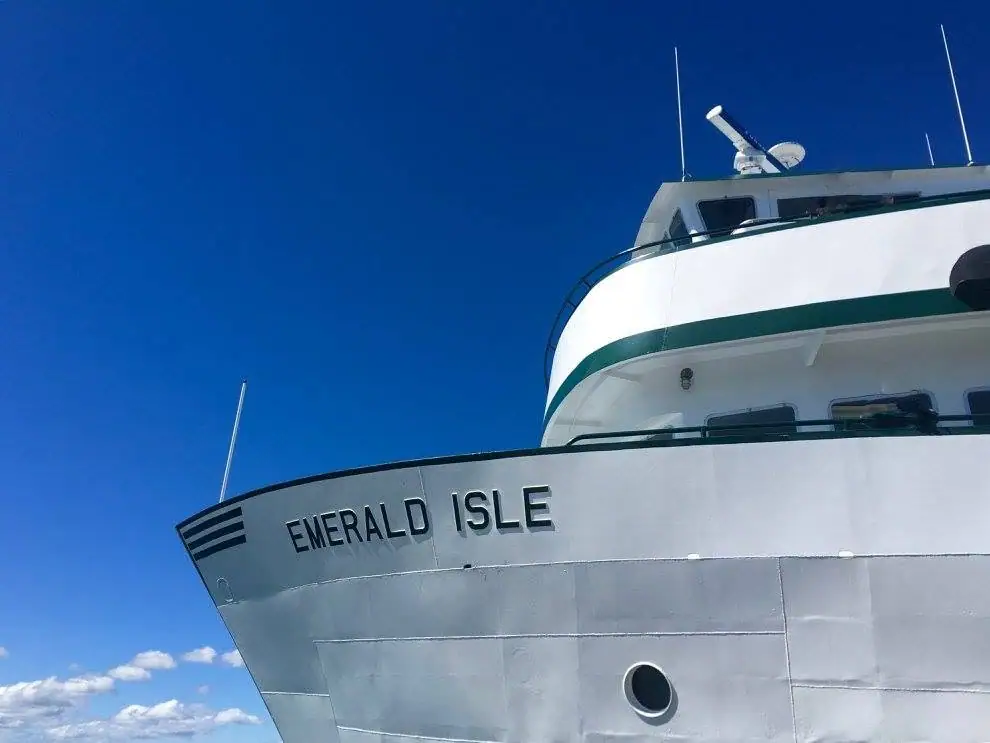 Close-up of a white passenger ferry’s bow with its name displayed in large letters.