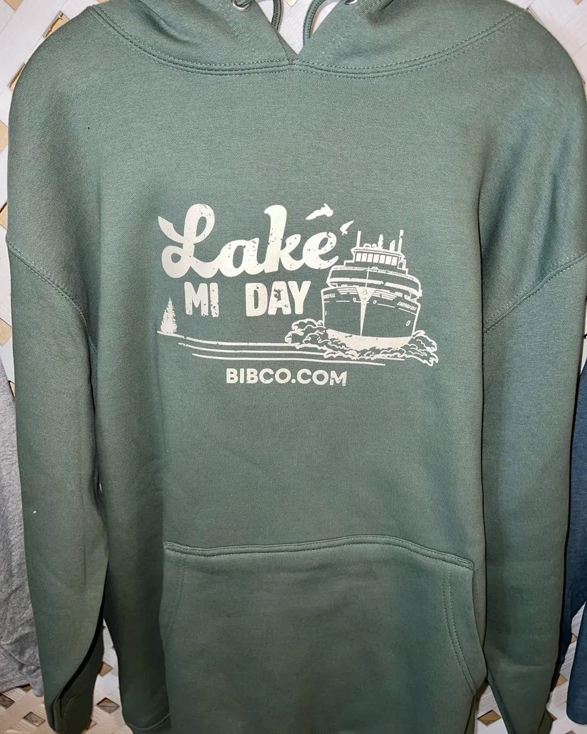 Green hooded sweatshirt with a white ferry illustration and the words “Lake MI DAY” and “BIBCO.COM.”