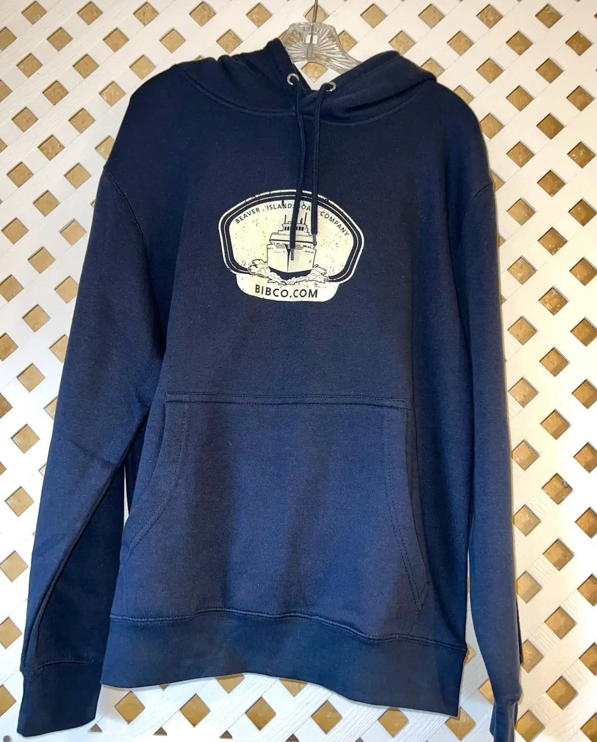 Navy hooded sweatshirt with a vessel graphic and printed company lettering on the chest.