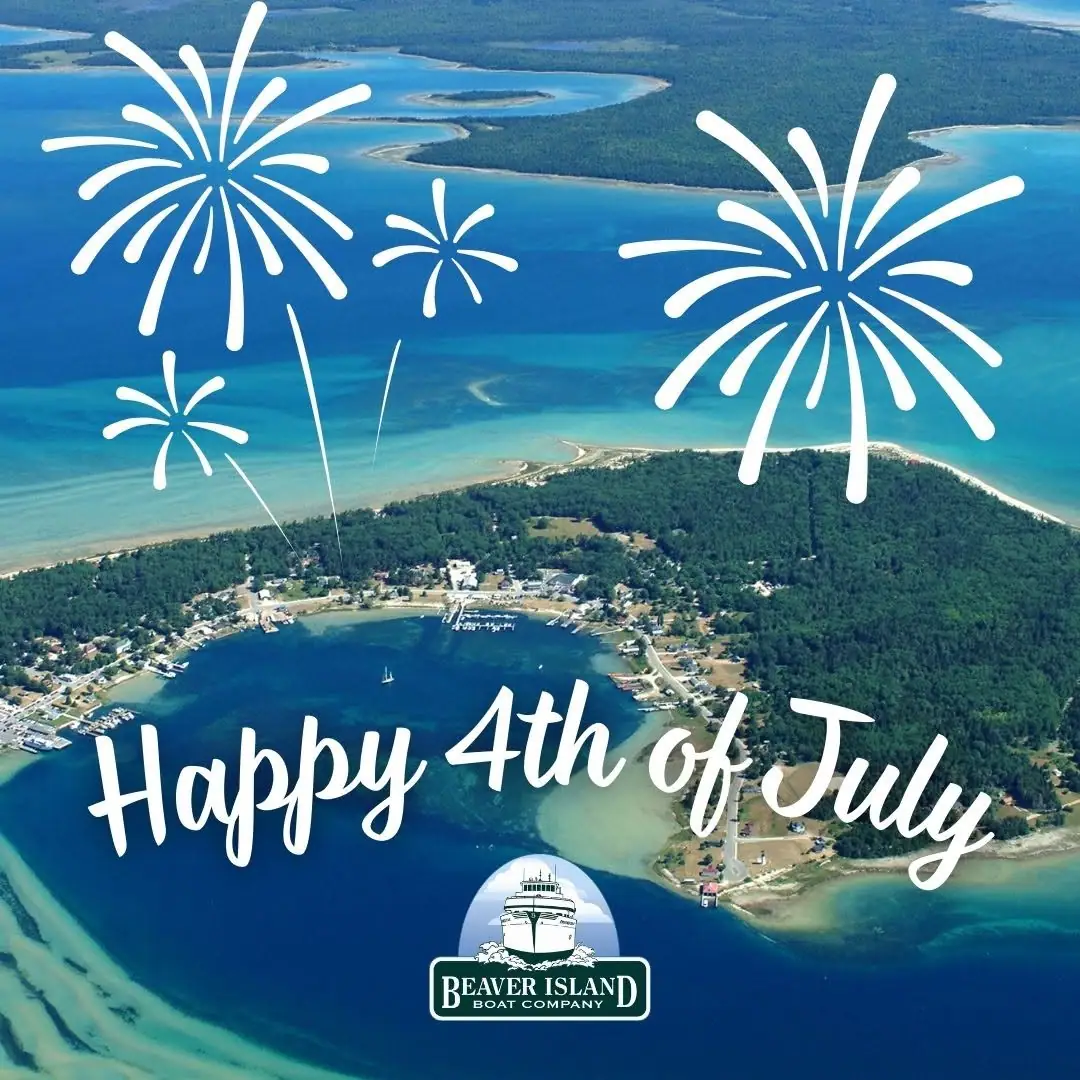 Aerial view of a wooded shoreline community with graphic fireworks and a holiday greeting.
