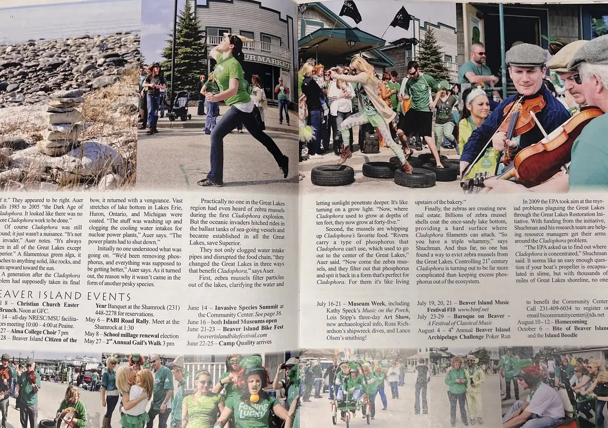 Photograph of an open printed publication showing an alga article, event calendar, shoreline, crowds, and a violinist.