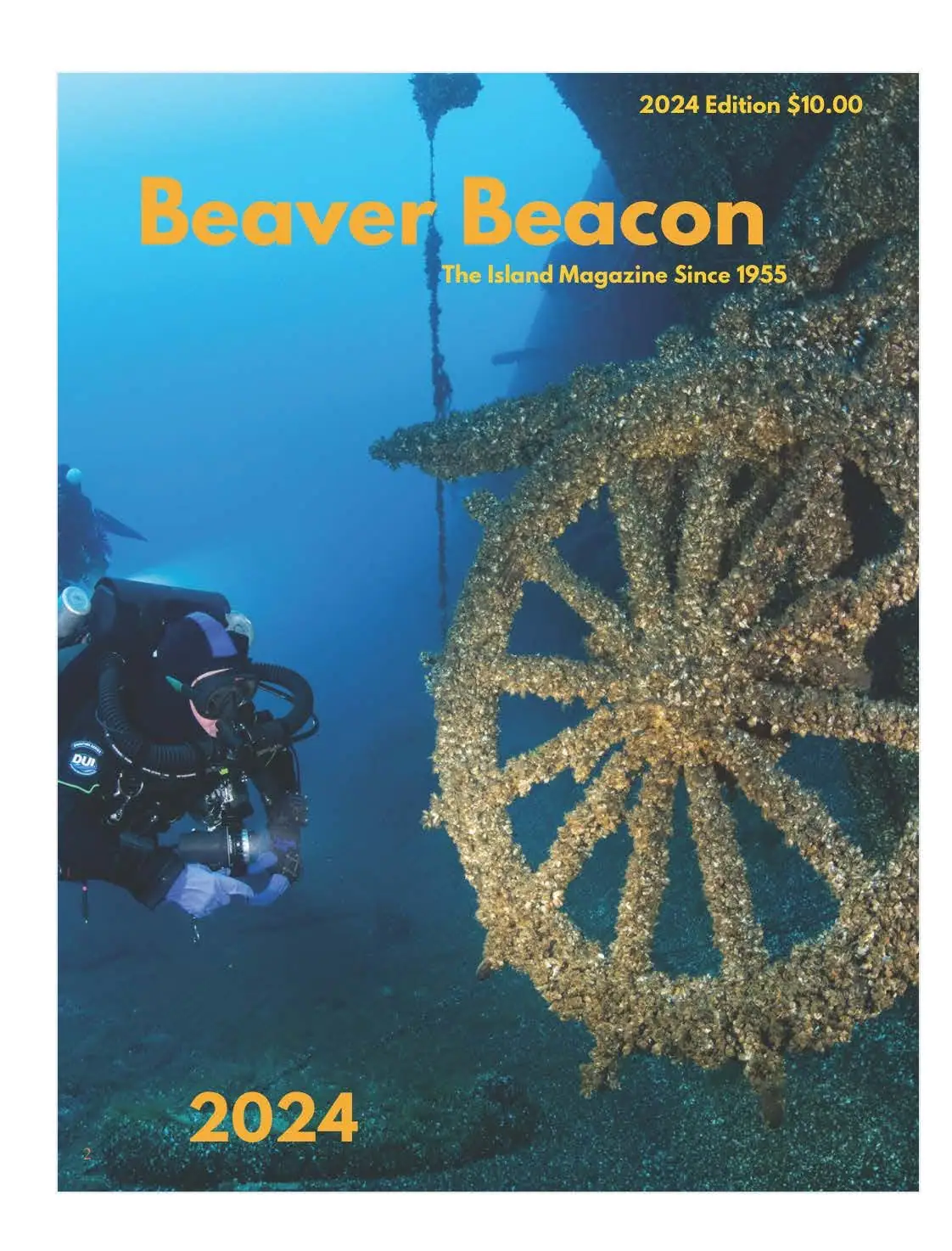 Magazine cover showing a scuba diver beside a submerged, growth-covered ship's wheel.