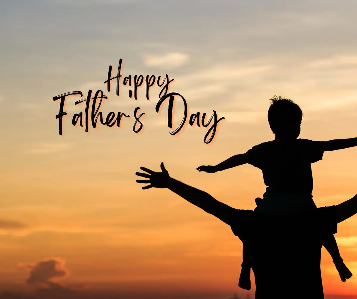 A silhouetted adult carries a child on their shoulders beneath the words “Happy Father's Day.”