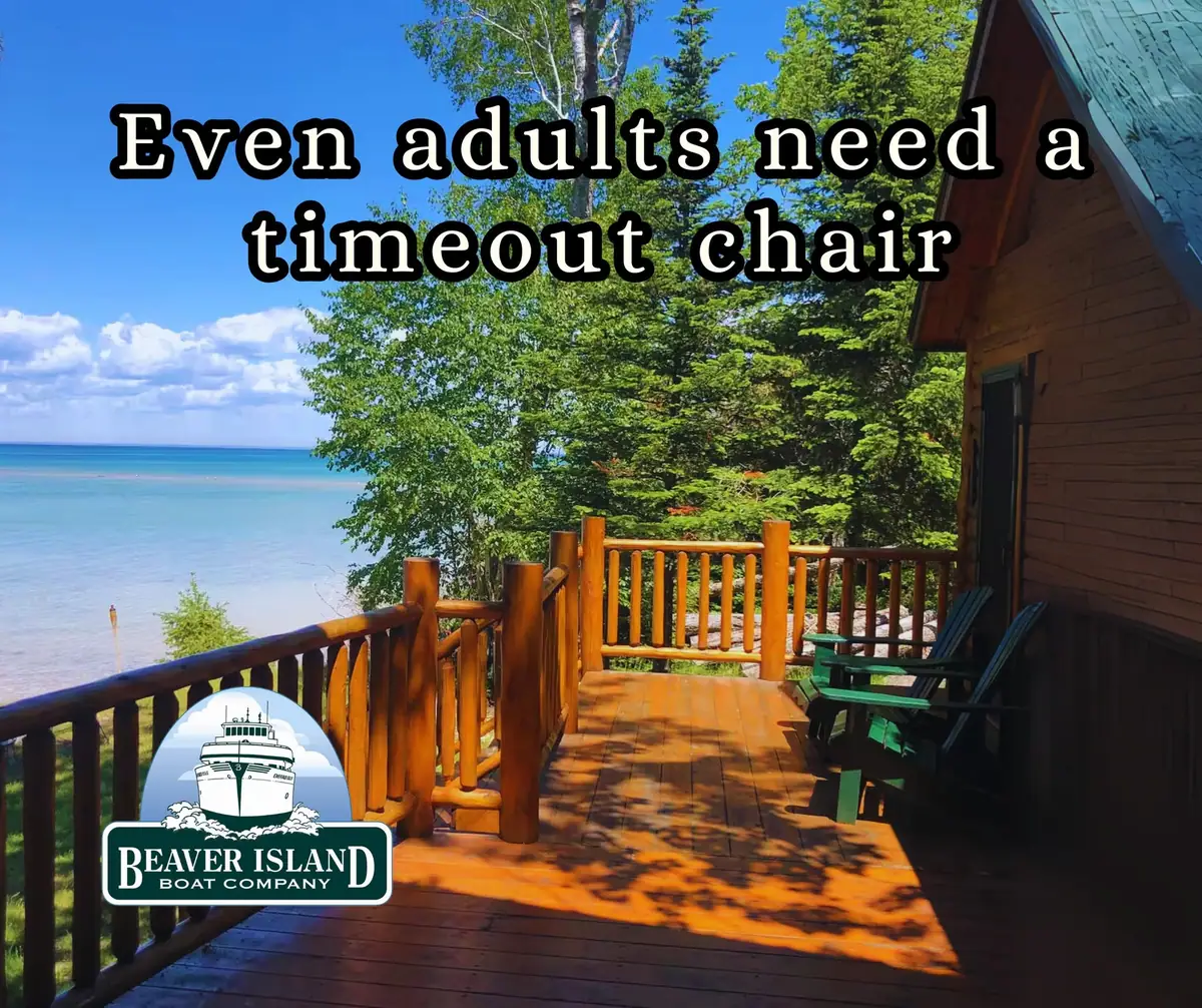 A wooden deck with green chairs overlooks clear blue water, with a text overlay and boat-company logo.