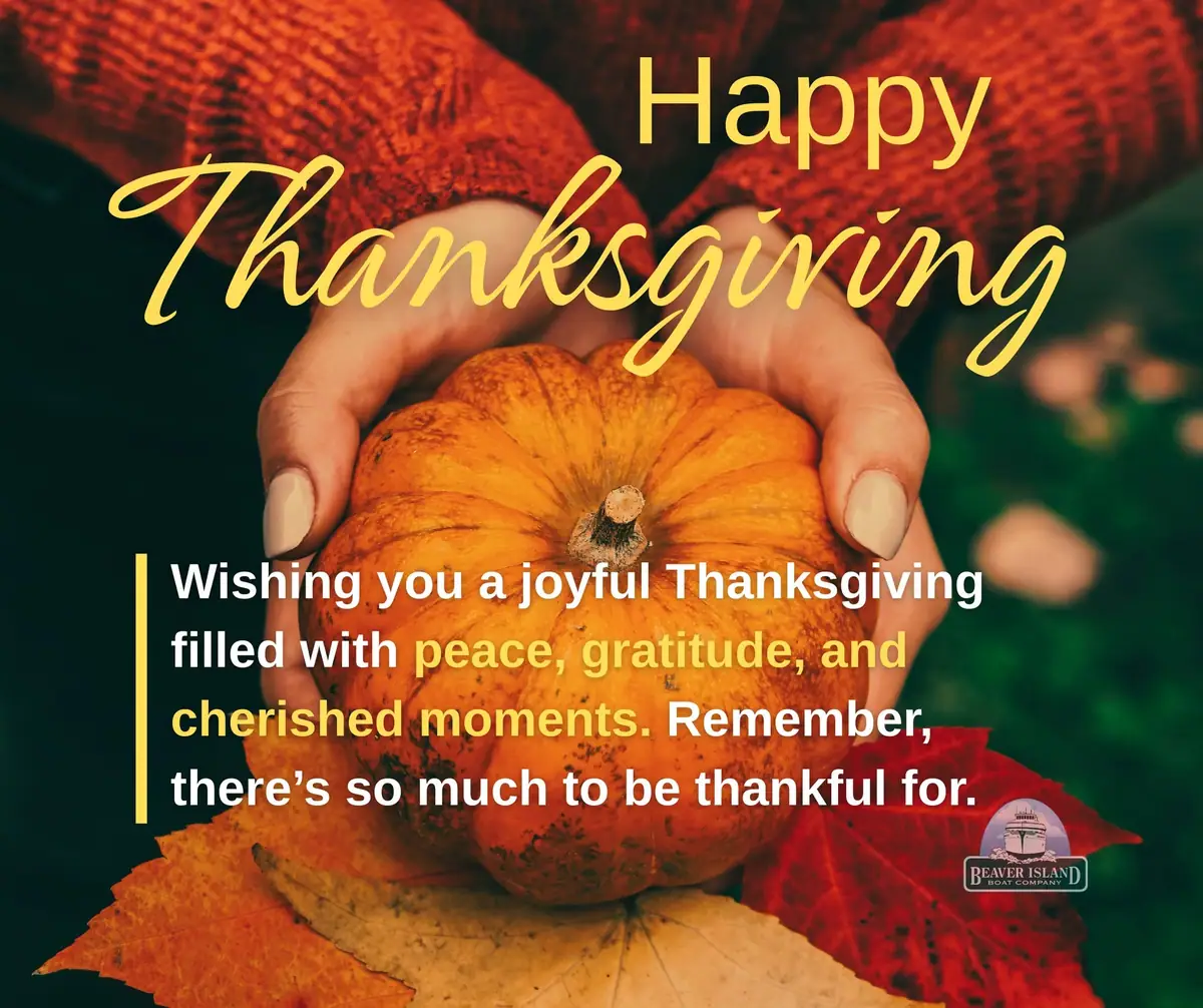 Thanksgiving greeting graphic with a pumpkin held above autumn leaves and overlaid text.