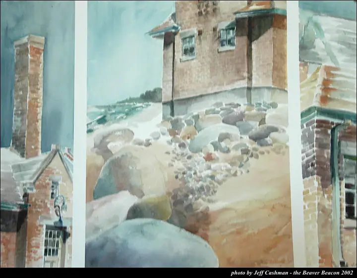 Photograph of watercolor panels depicting a brick tower and buildings among shoreline rocks.