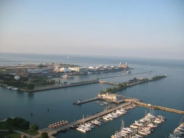 Aerial view of a marina, piers, sailboats, and a waterfront amusement complex.