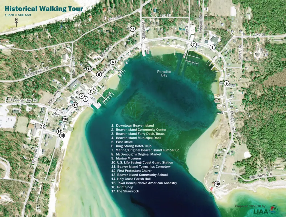 Color aerial walking-tour map showing roads, shoreline, docks, numbered landmarks, and a north arrow.