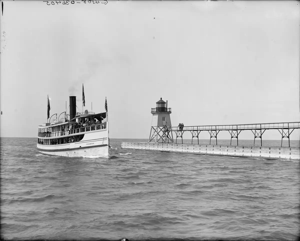Charlevoix light and harbour entrance, with the steamer Chequamegon (c.
