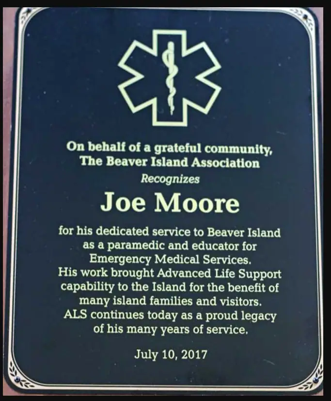 A dark blue award plaque with a Star of Life emblem and centered commemorative lettering.